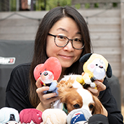 Jin Ha Lee with BTS memorabilia and her dog.